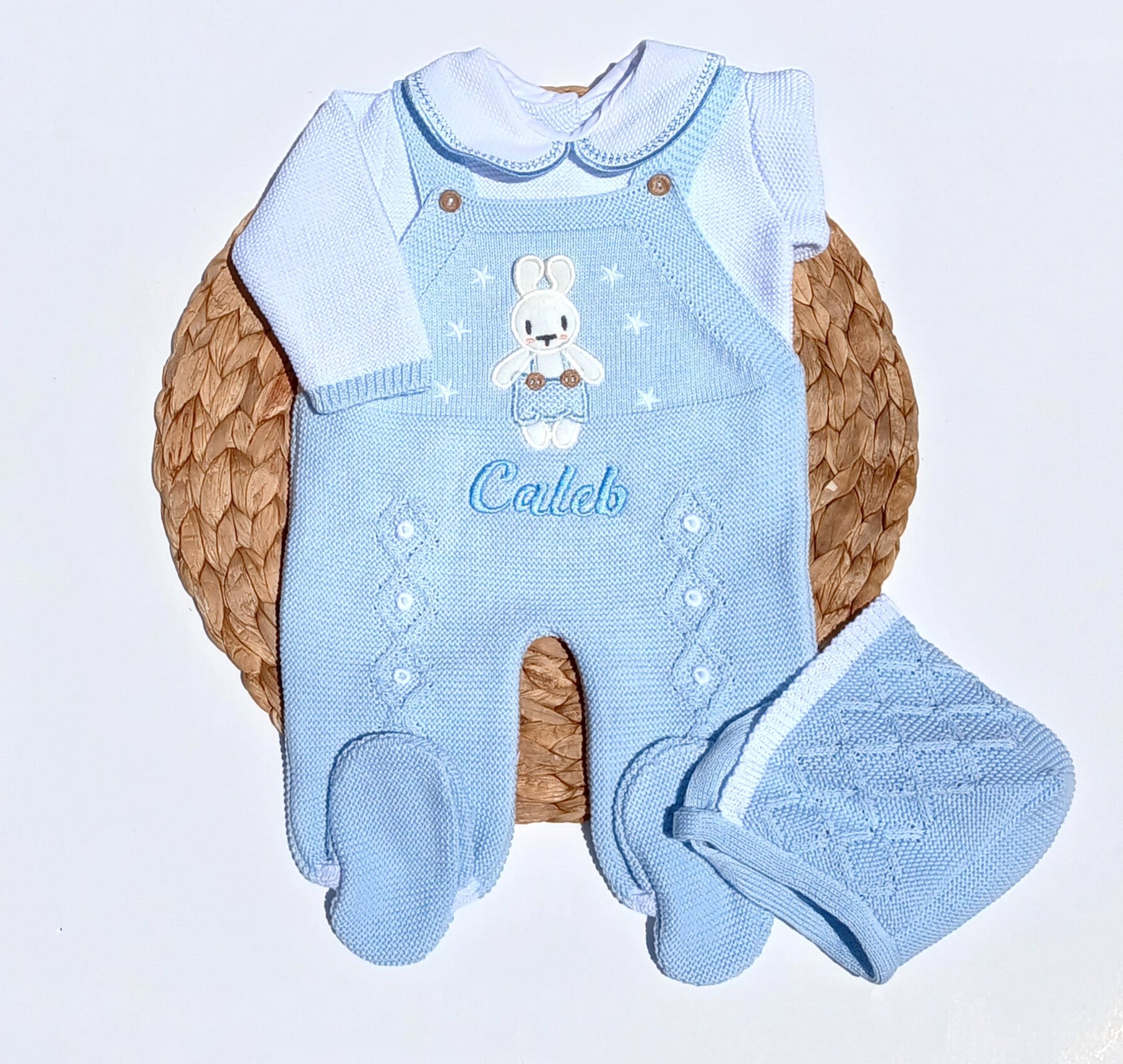 Baby blue knitted outfit with bunny design and matching blanket on a woven basket
bunny newborn going home outfit, newborn boy take me home outfit, baby boy knit outfit, baby knit coming home set, classic baby clothing, traditional baby clothing. with baby's name embroidery on the outfit