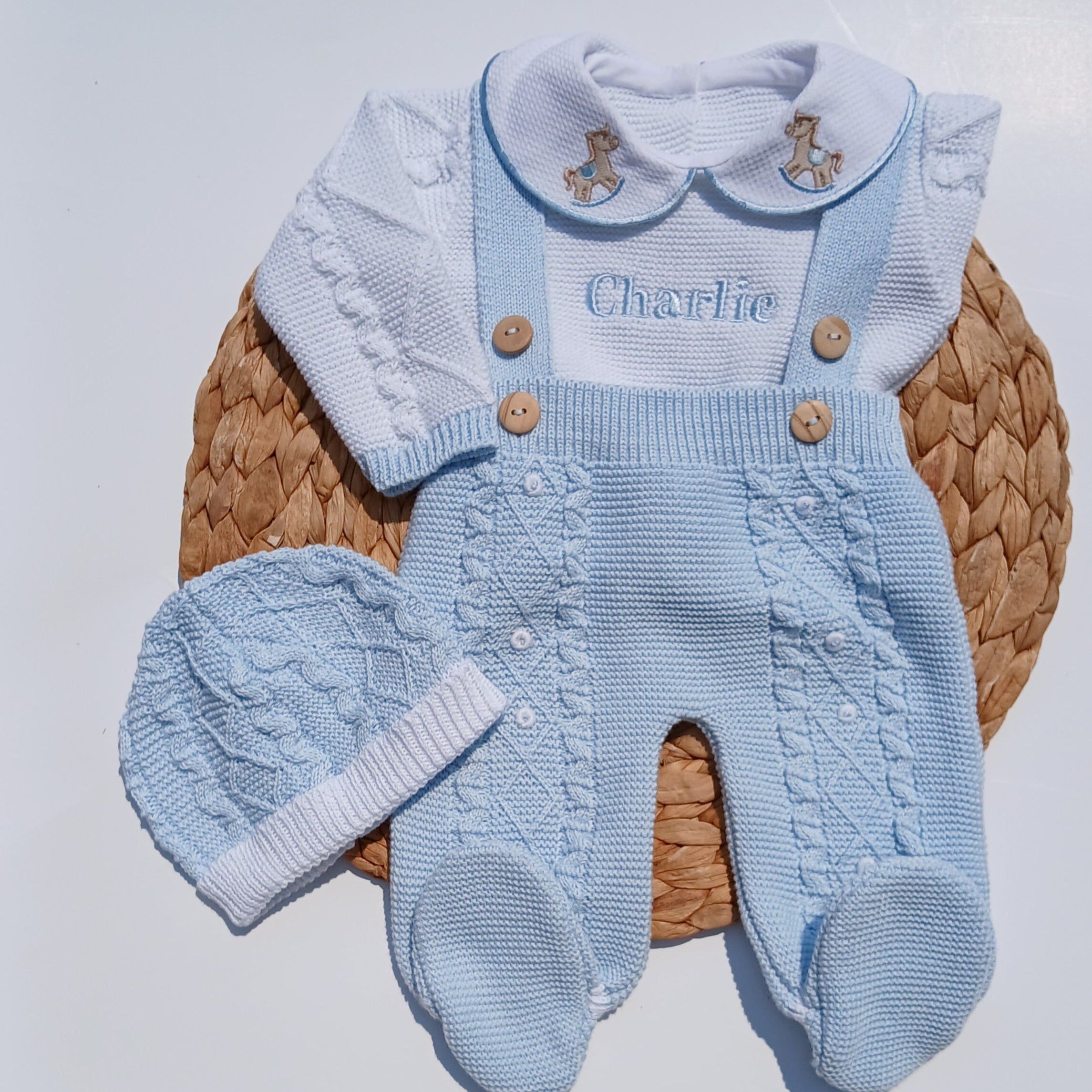 Blue knitted baby outfit with hat on a newborn going home set