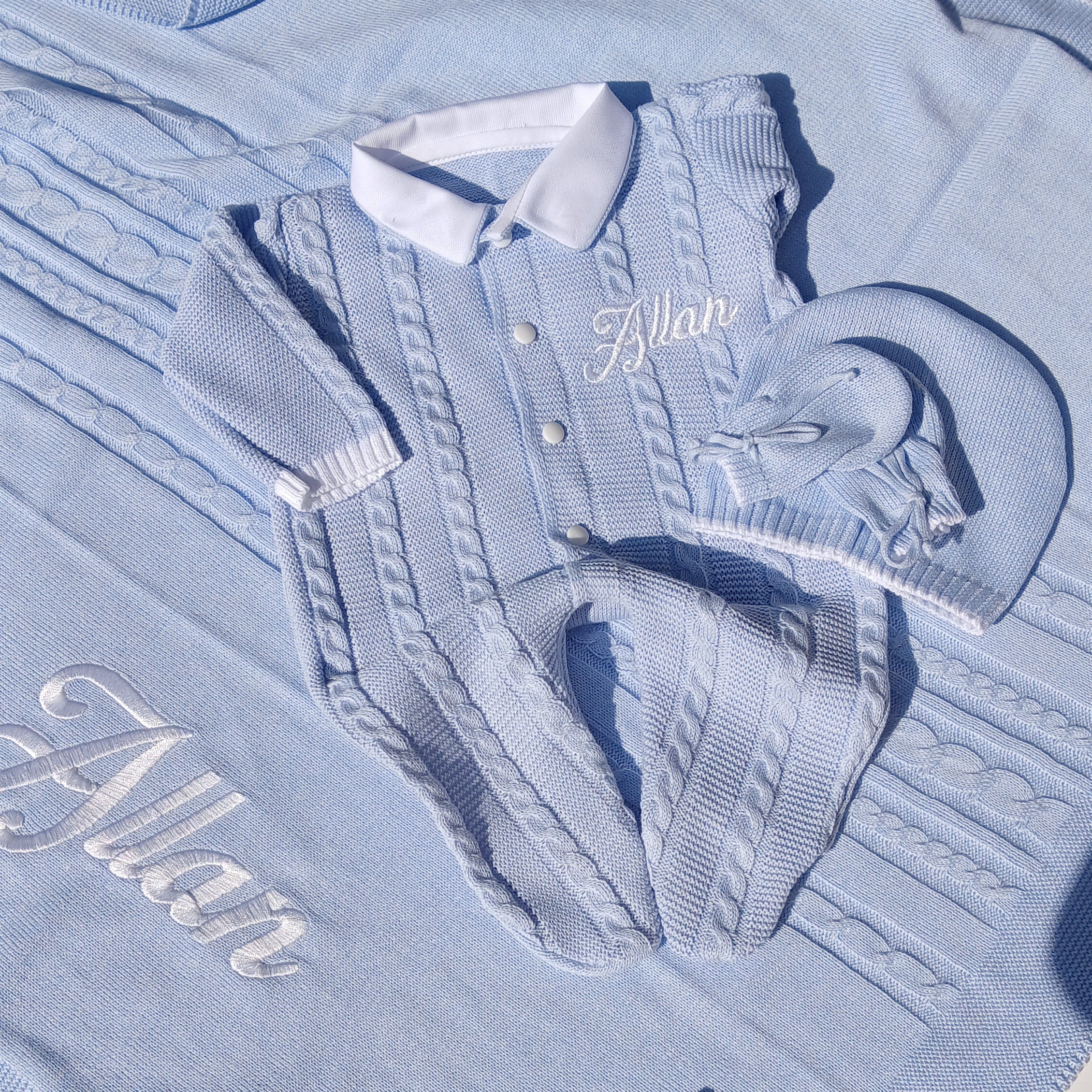 Light blue shirt with embroidered text on a white surface