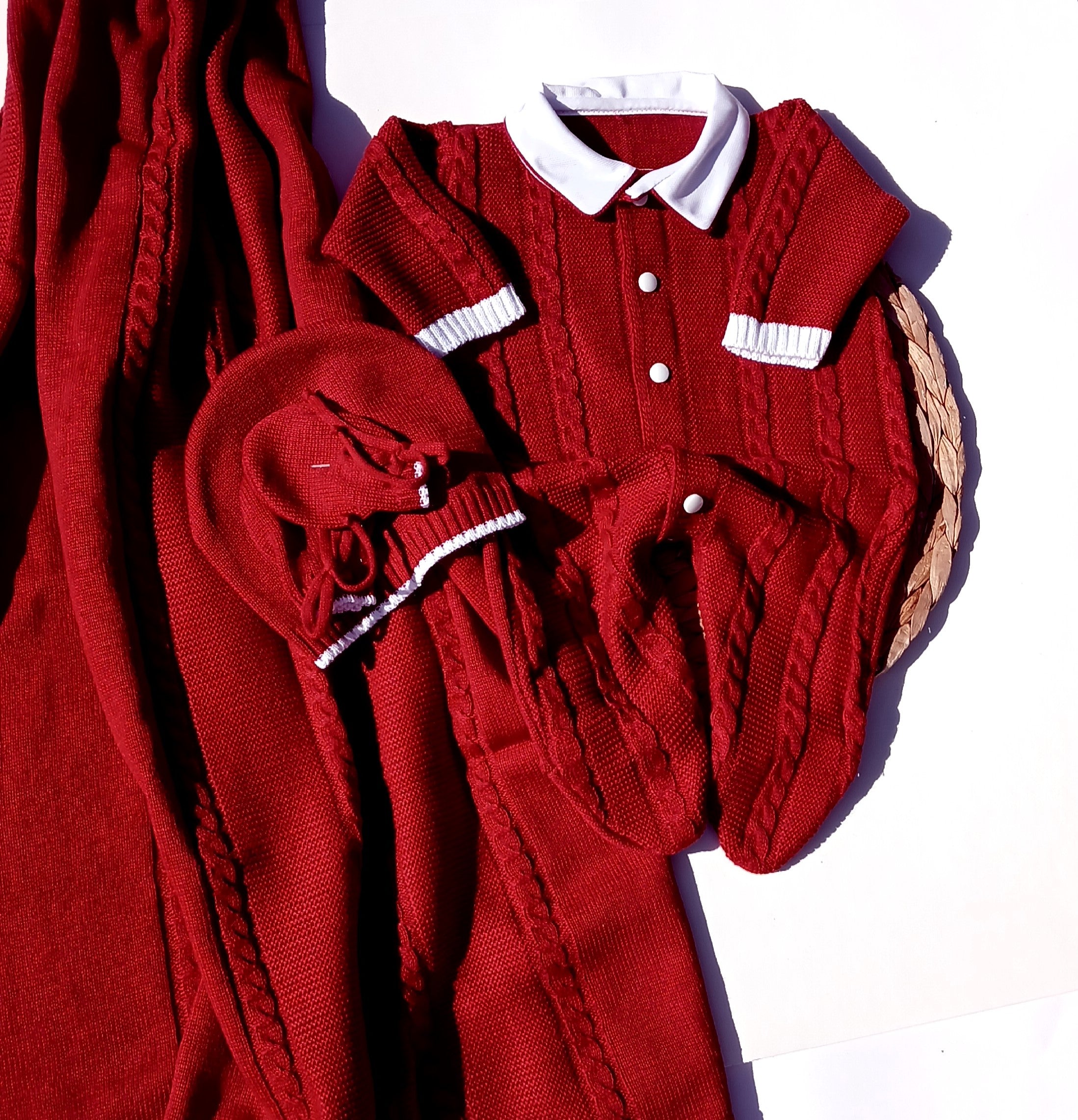 Red knitted cardigan with white buttons on a light purple background, Celebrate the season in style with this charming boys Christmas outfit