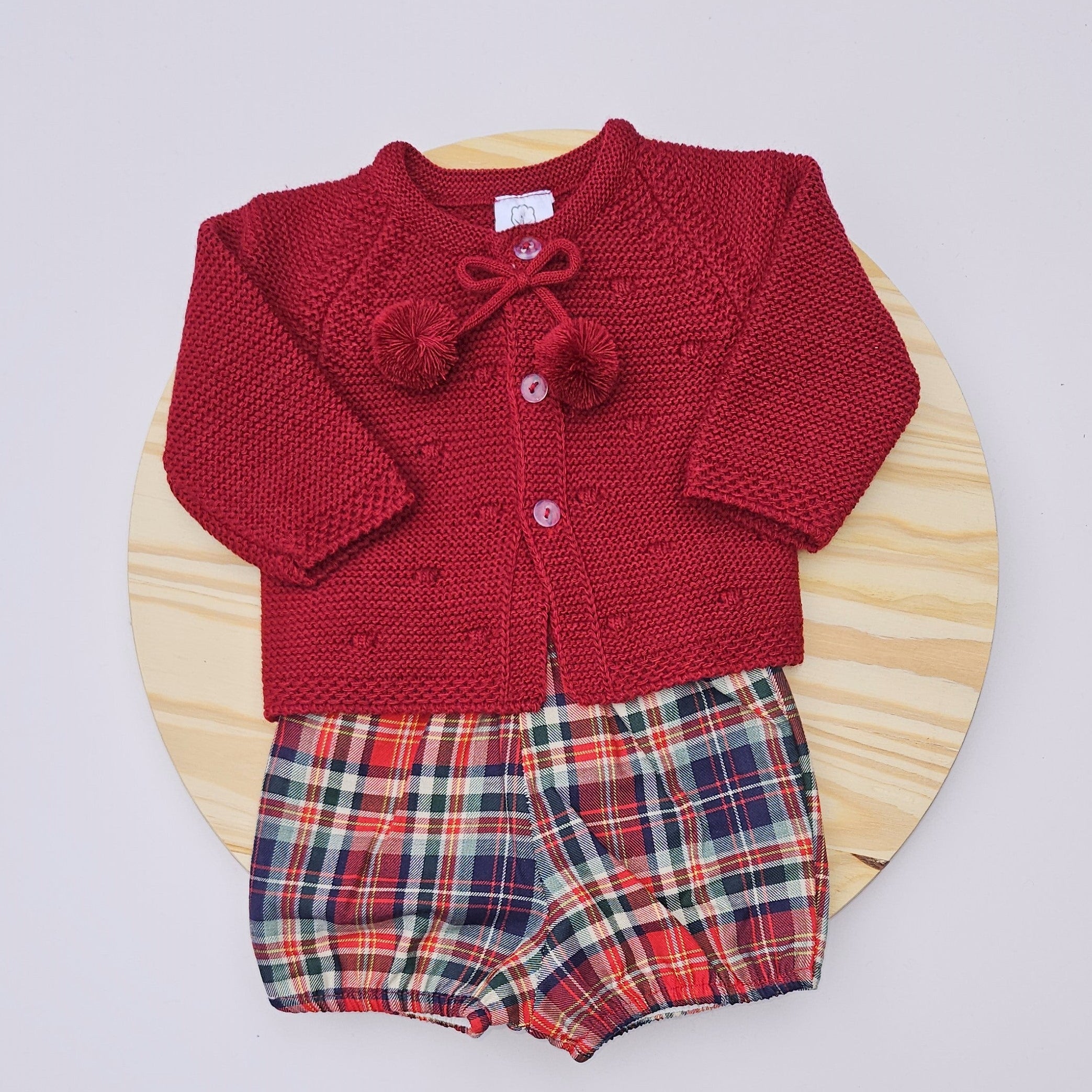 Red knitted cardigan with a bow and plaid shorts Celebrate the season in style with this charming boys Christmas outfit featuring a cozy knitted sweater paired with a coordinating diaper cover. Crafted from soft, breathable cotton, this two-piece set keeps your little one comfortable and festive all day long. The classic color options make it perfect for holiday photos, family gatherings, or everyday wear during the Christmas season. Easy to dress and undress, this outfit combines practicality with holiday