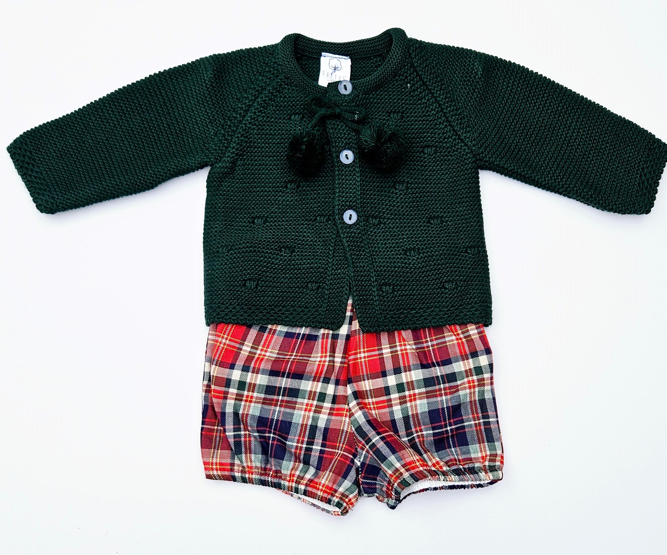 Celebrate the season in style with this charming girls unisex Christmas outfit featuring a cozy knitted sweater paired with a coordinating plaid bloomers. This two-piece set keeps your little one comfortable and festive all day long. The classic color options make it perfect for holiday photos. Easy to dress and undress.