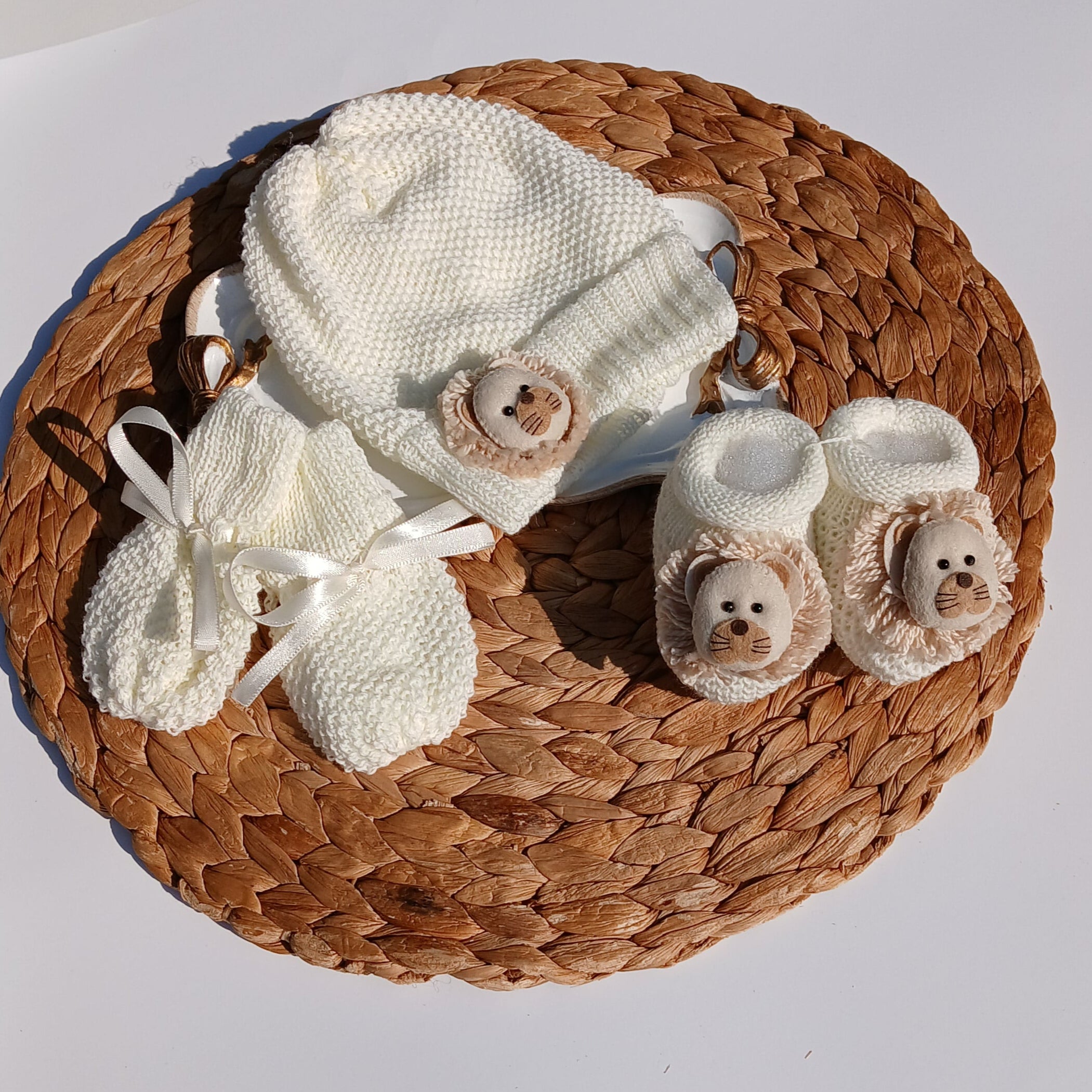 Lion Baby hat, booties, and socks on a Mittens, knit set