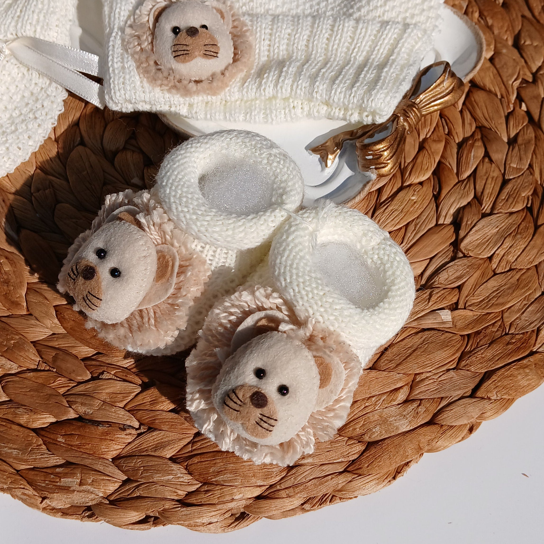 Lion Baby hat, booties, and socks on a Mittens, knit set