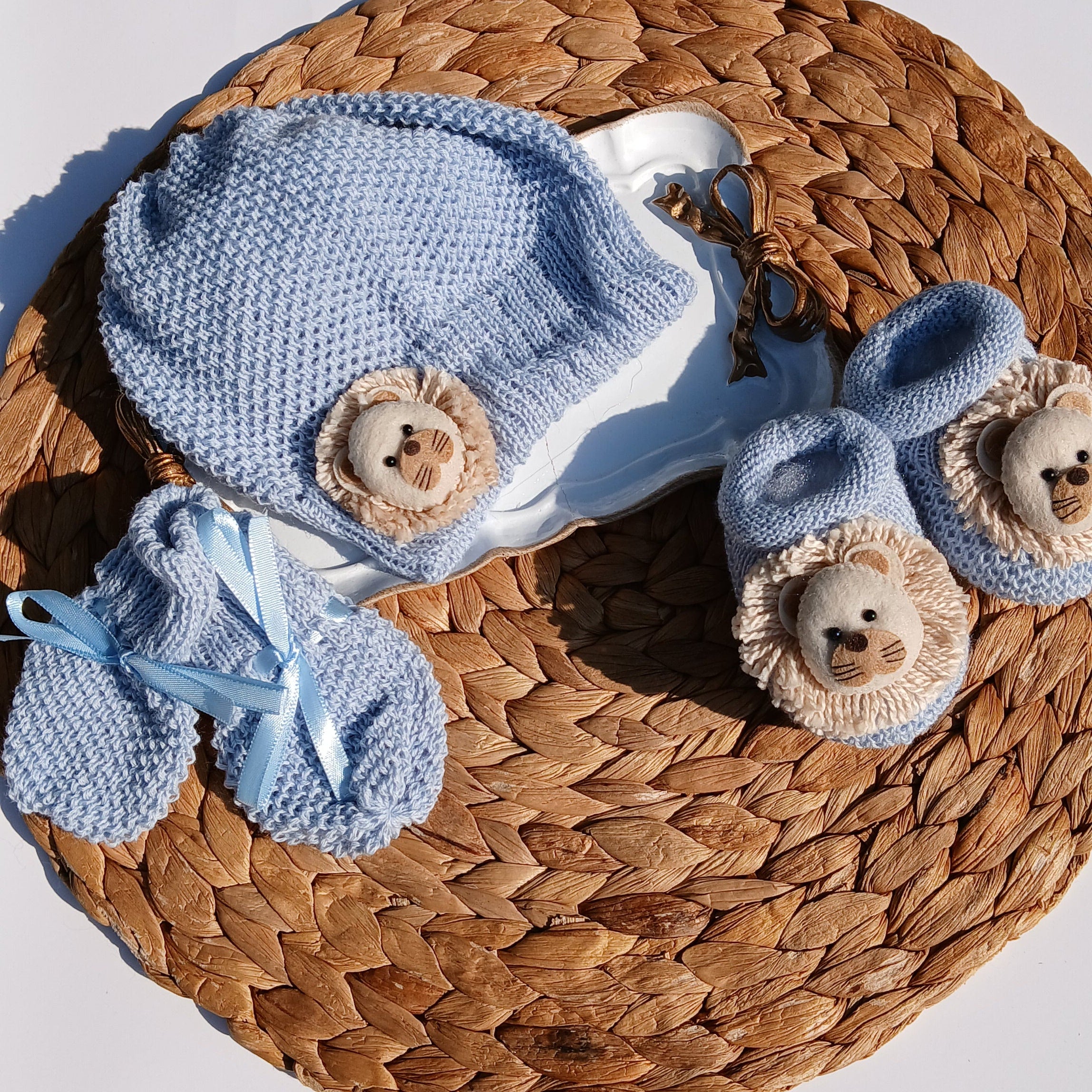 Lion Baby hat, booties, and socks on a Mittens, knit set