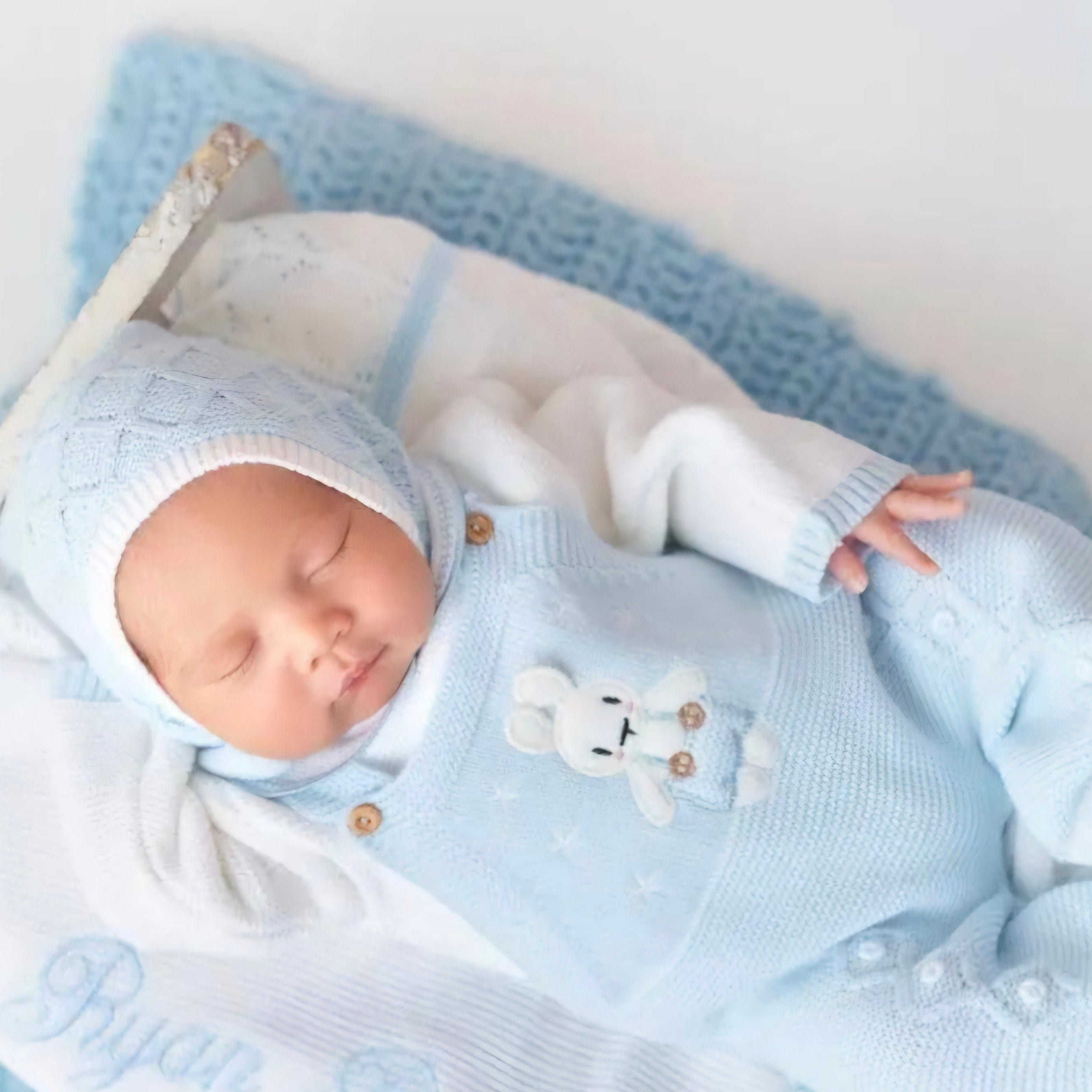 newborn baby boy with baby bunny knitted outfit, name embroidered on the outfit