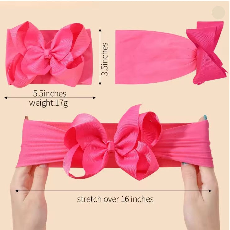Pink headband with large bow, showing measurements and stretchability on a beige background.