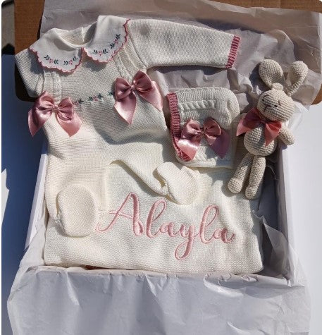 Baby outfit set with dress, hat, and toy in a box, personalized with 'Asliayla'.