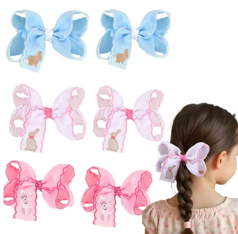 Set of colorful hair bows with a girl wearing one, on a white background
