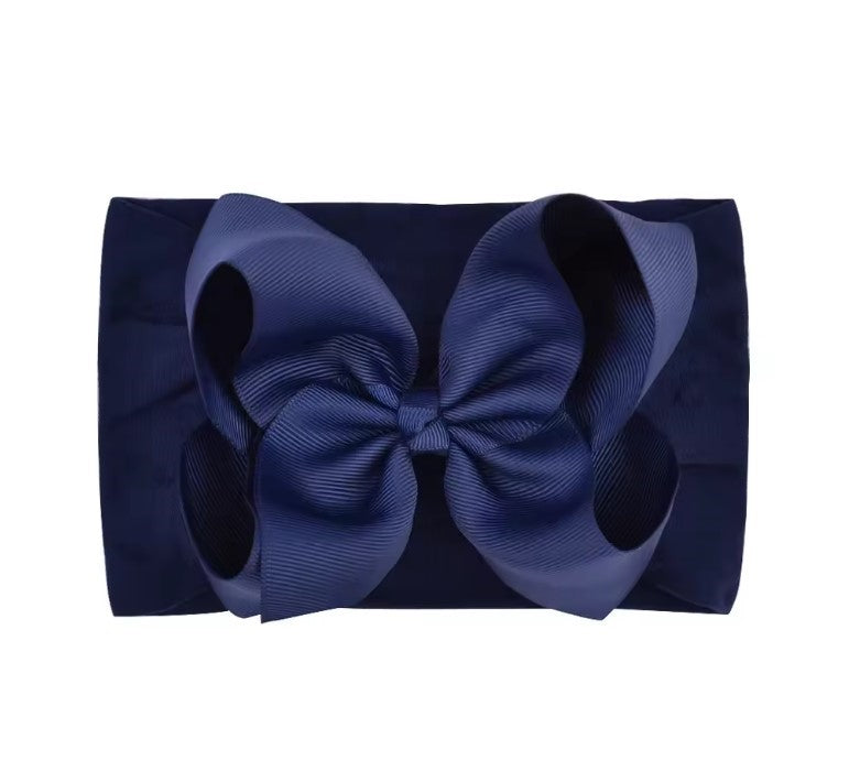 Navy blue clutch bag with a large bow on a white background large baby bow, baby headband, oversized baby bow