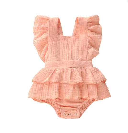 Pink ruffled baby romper on a white background