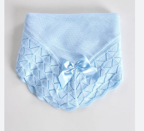 Light blue baby blanket with a bow on a light gray background