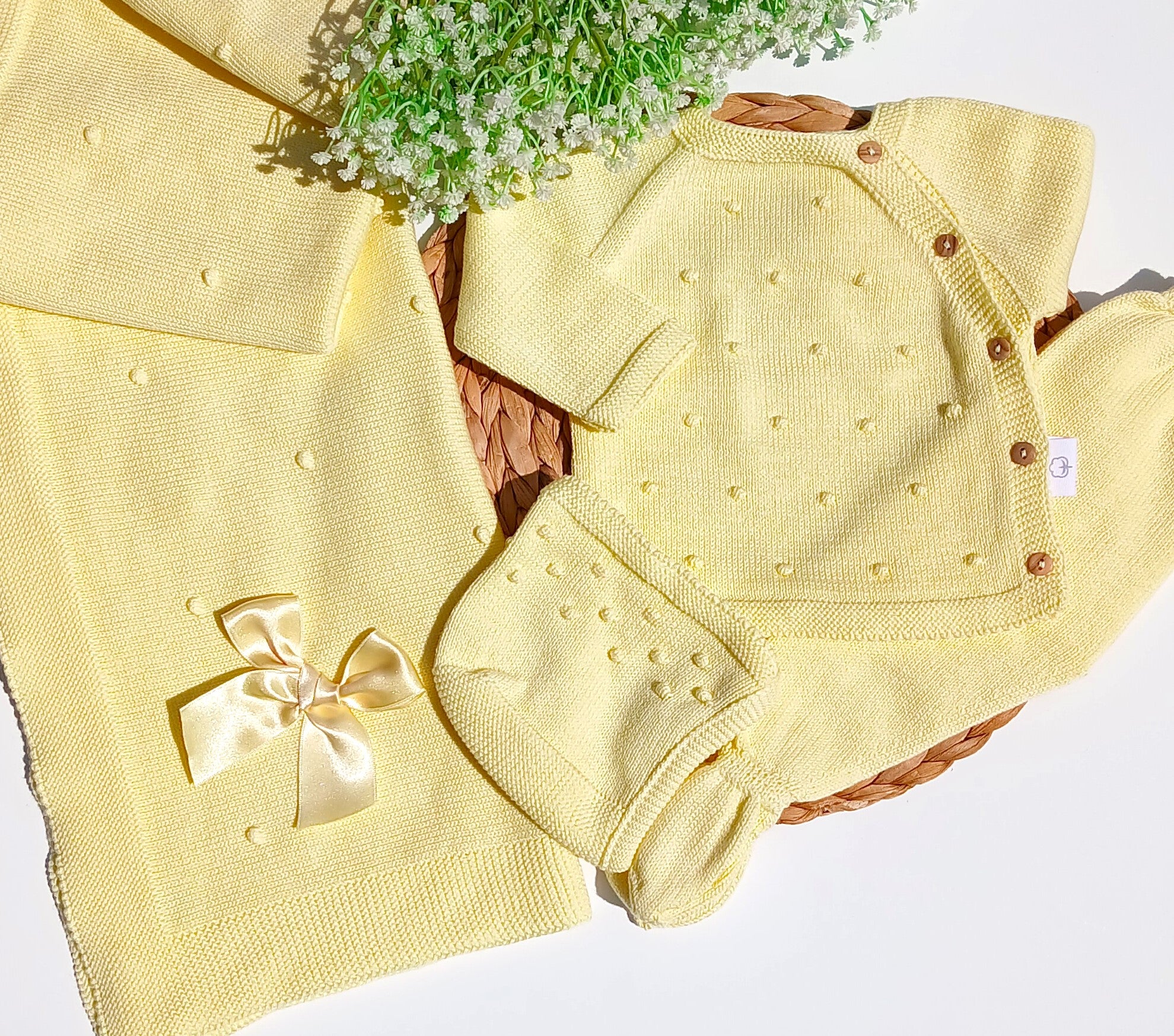 Yellow baby outfit with a bow and bloomers on a white background newborn yellow neutral set coming home