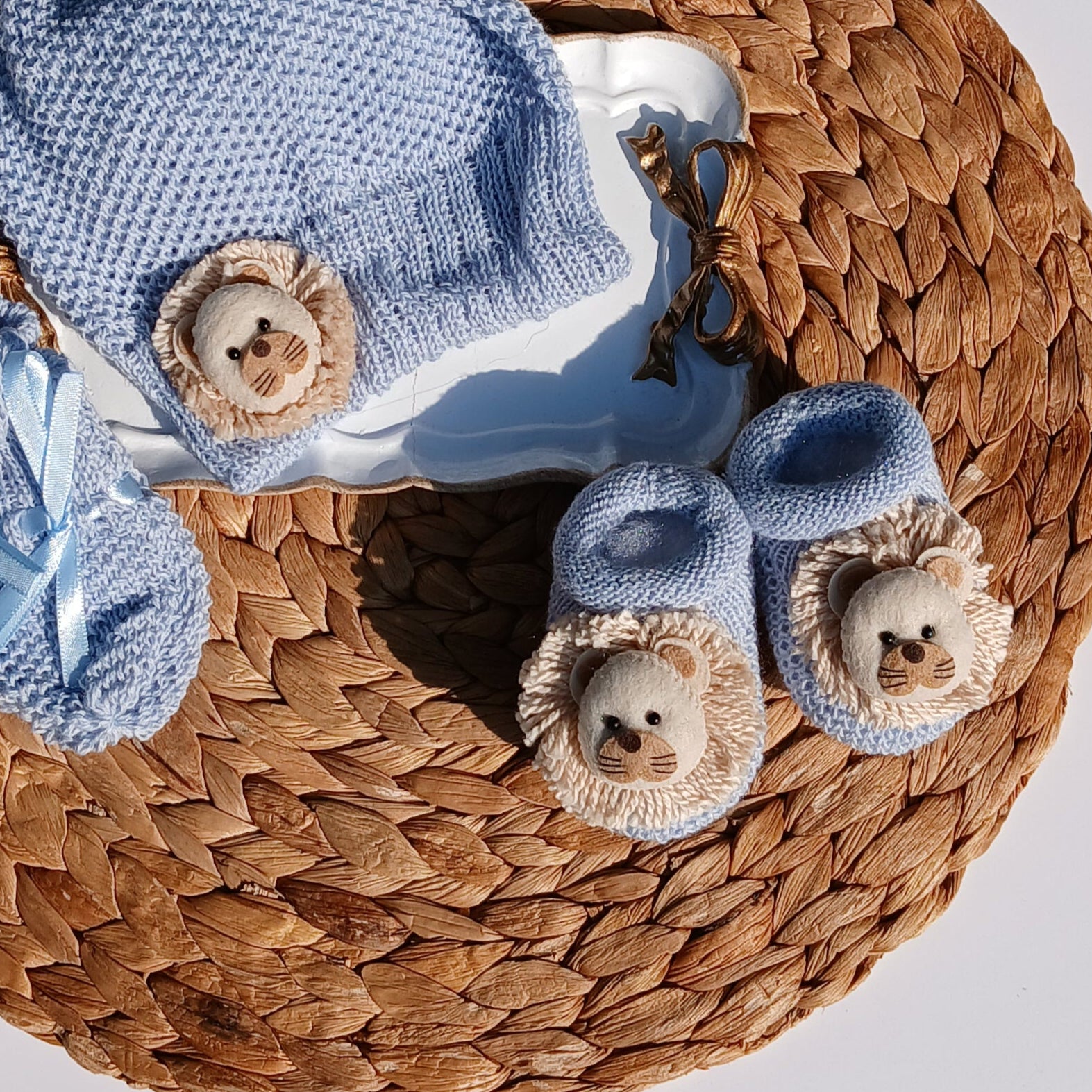 Lion Baby hat, booties, and socks on a Mittens, knit set in blue