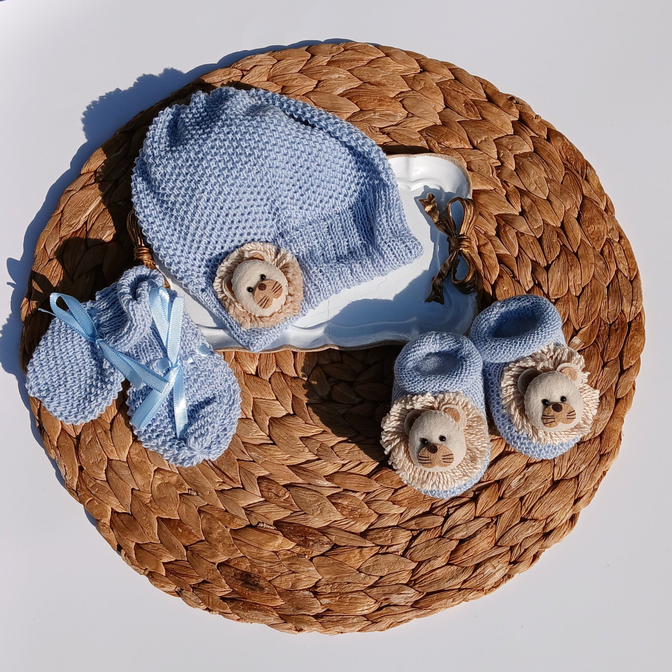 Lion Baby hat, booties, and socks on a Mittens, knit set