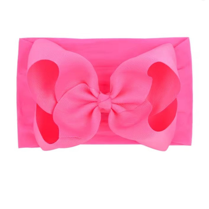 deep Pink clutch with a large bow on a white background , large baby bow, baby headband