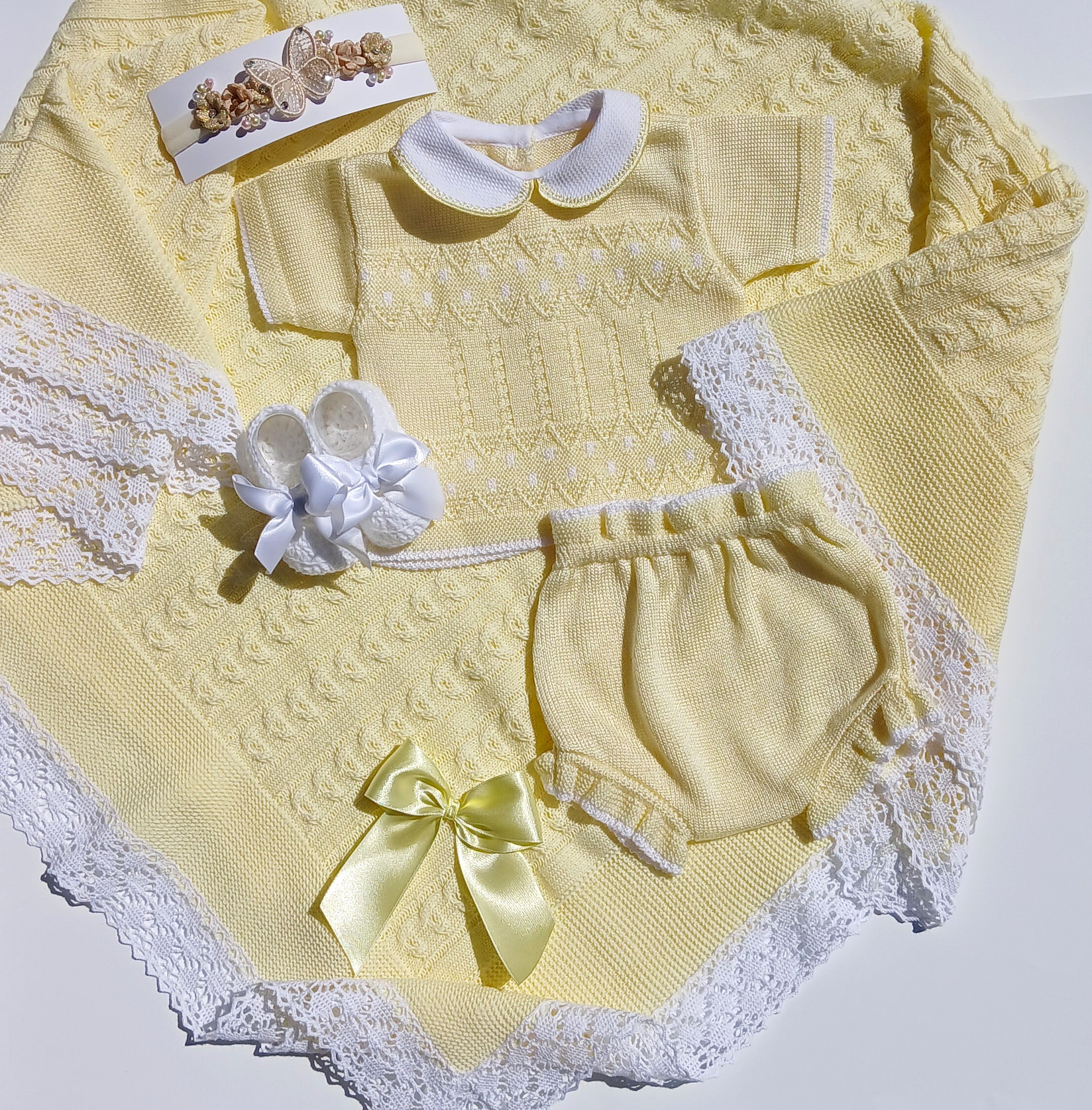 Yellow baby outfit with matching shoes and bow on a white Yellow summer baby outfit with matching butterfly headband and white bootie w a bow, yellow knit baby blanket background