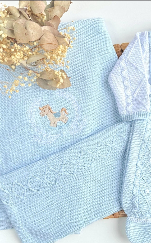Light blue knitted blanket with a embroidered design on a white background Embroidered blanket with a horse design, baby blanket, and toy Newborn baby blanket