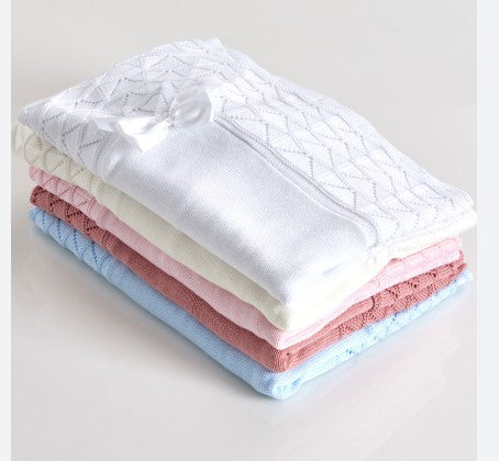Stack of folded fabric pieces in various colors on a light background