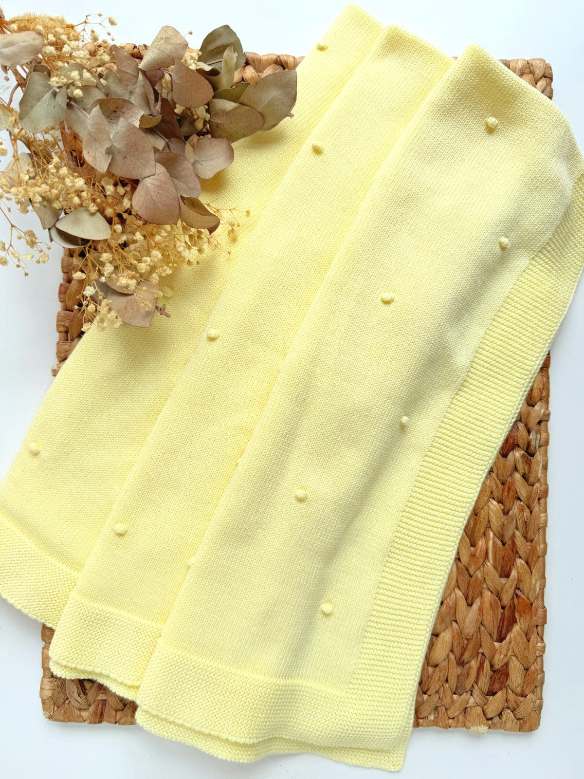 european yellow baby blanket Yellow fabric with polka dots on a woven surface