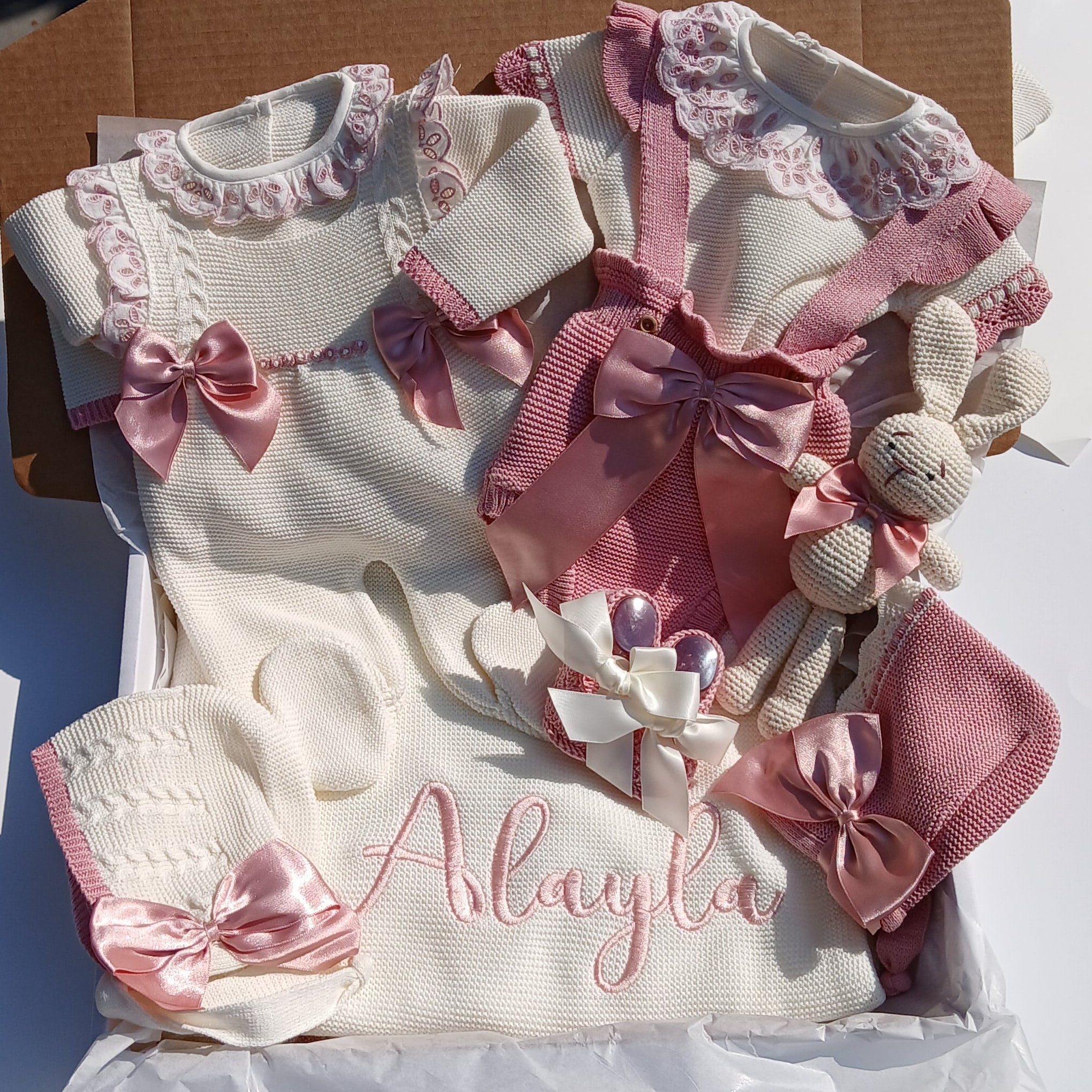 Baby outfit with pink bows and 'Allie' embroidered on a white background