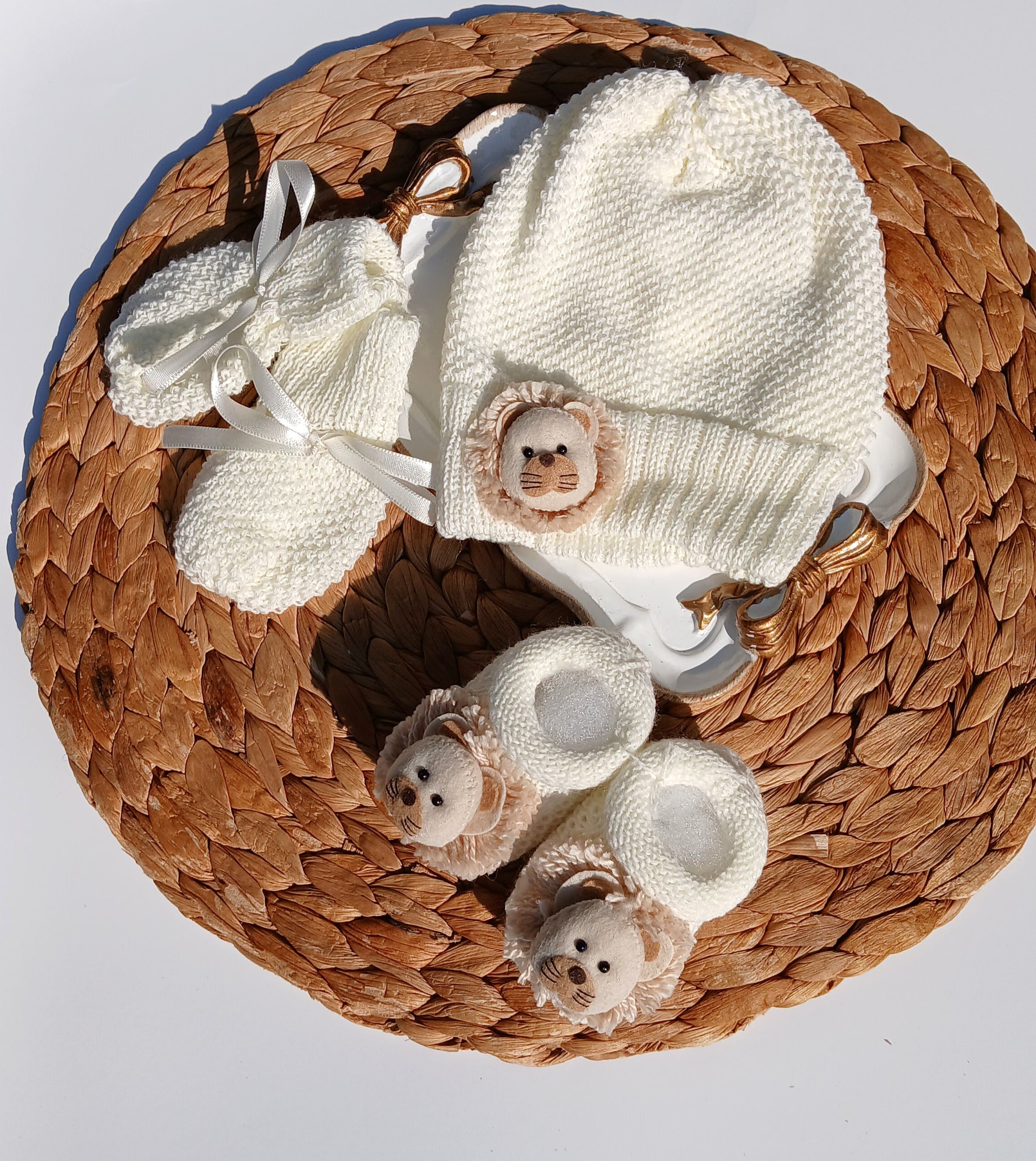 Lion Baby hat, booties, and socks on a Mittens, knit set