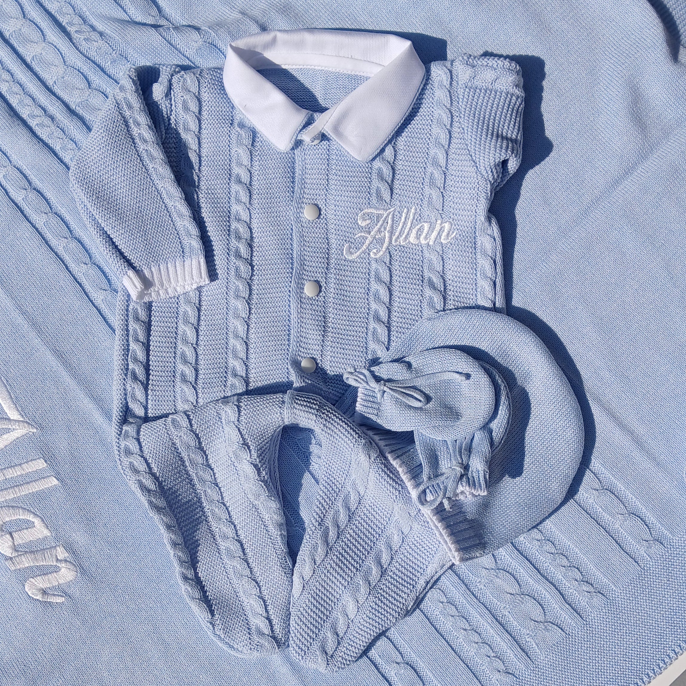 Blue denim jacket with a graphic design on a white surface
