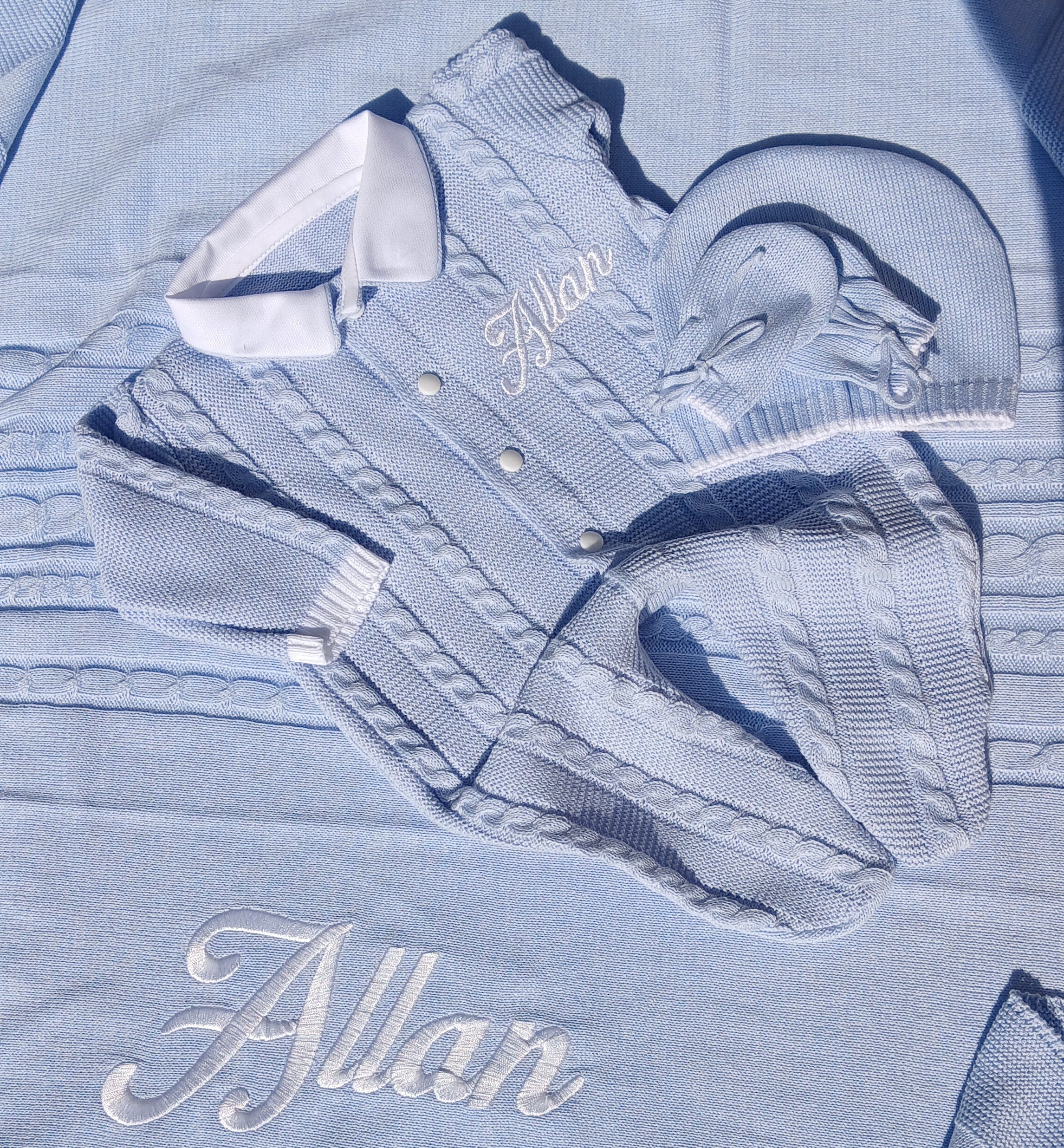 Light blue shirt with white embroidery on a dark surface