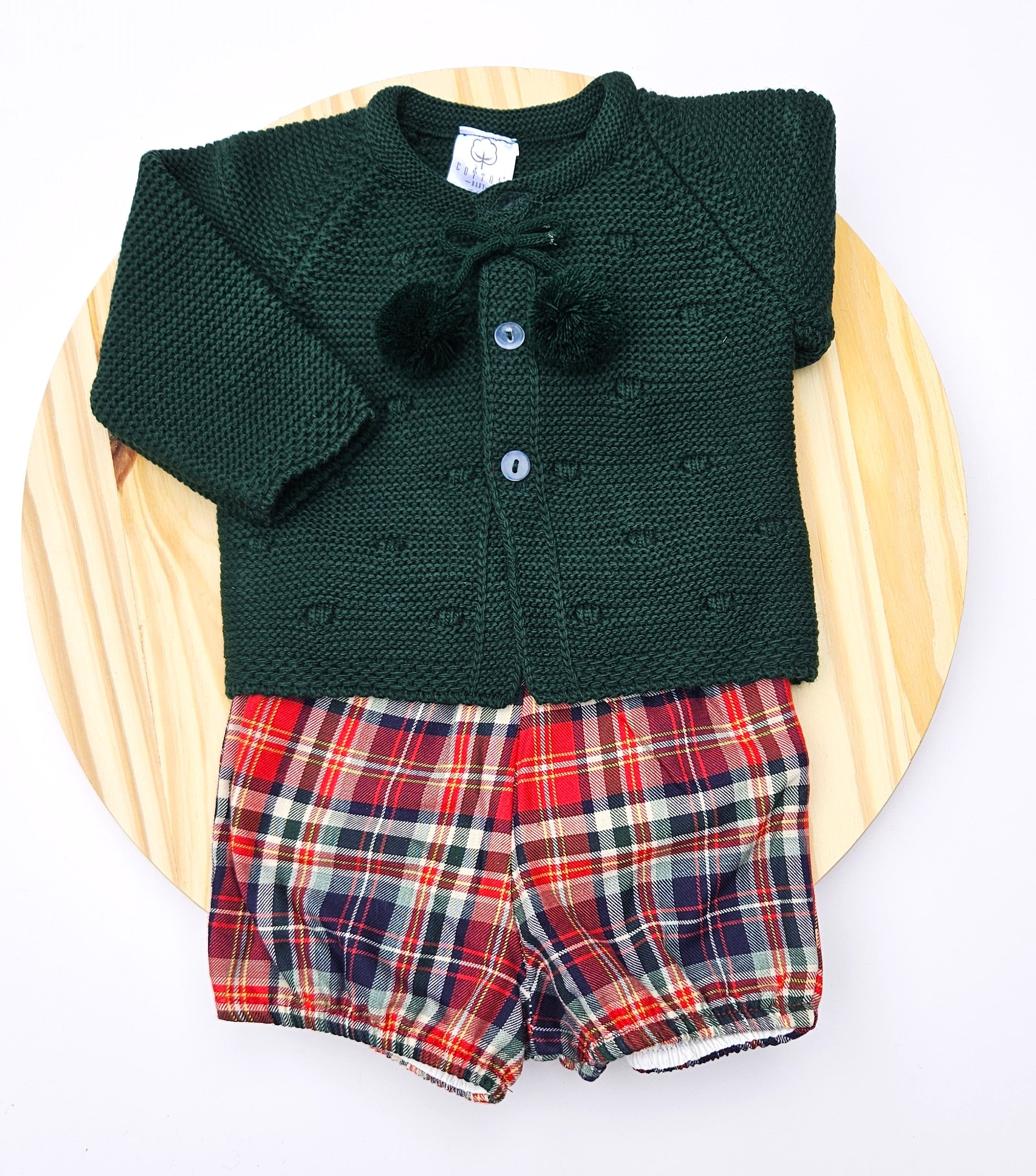 Celebrate the season in style with this charming girls unisex Christmas outfit featuring a cozy knitted sweater paired with a coordinating plaid bloomers. This two-piece set keeps your little one comfortable and festive all day long. The classic color options make it perfect for holiday photos. Easy to dress and undress.