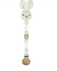 Wooden baby rattle shaped like a rabbit with beads on a white background