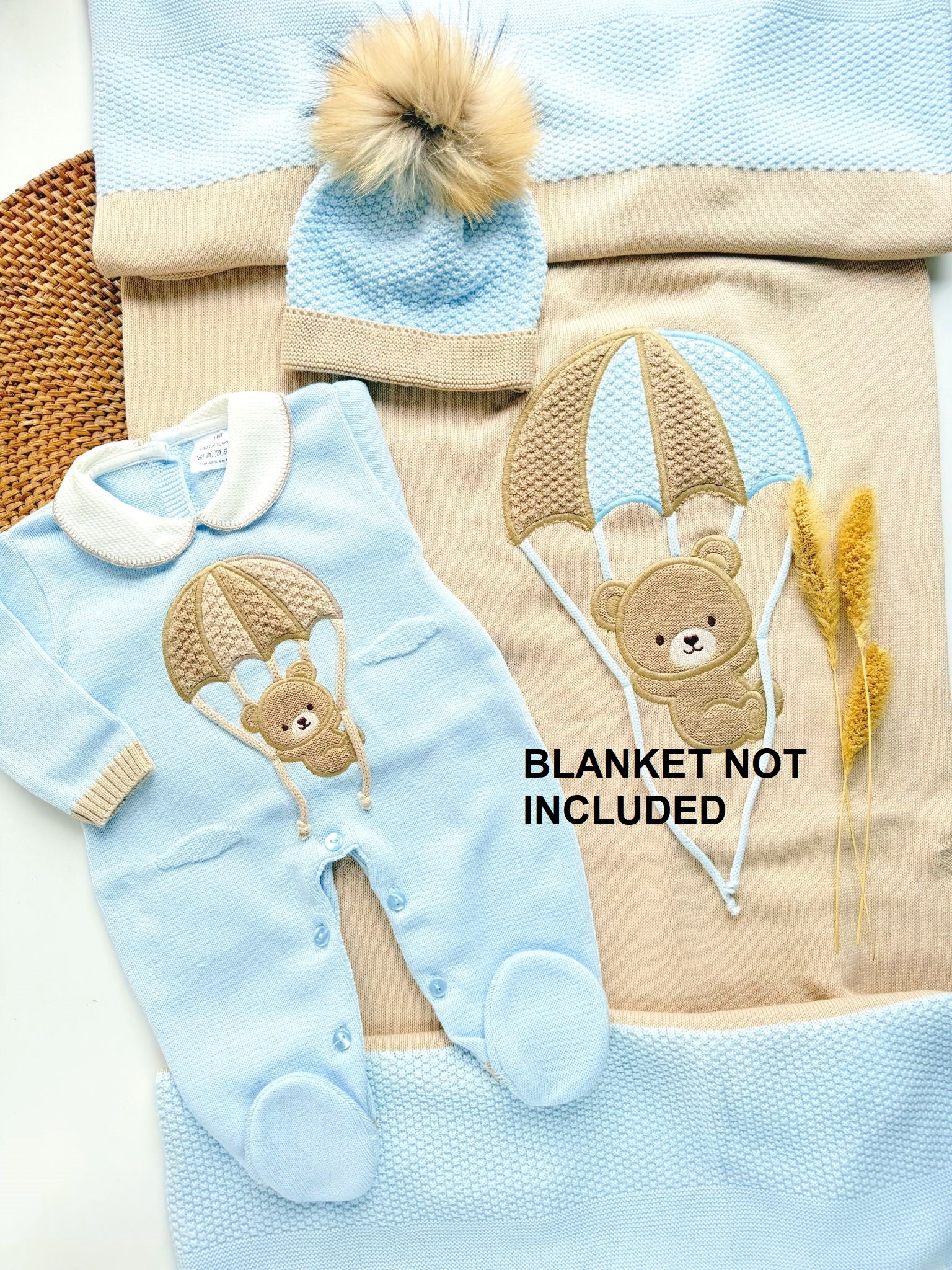 Baby outfit with bear design on a blanket, with text 'BLANKET NOT INCLUDED'.