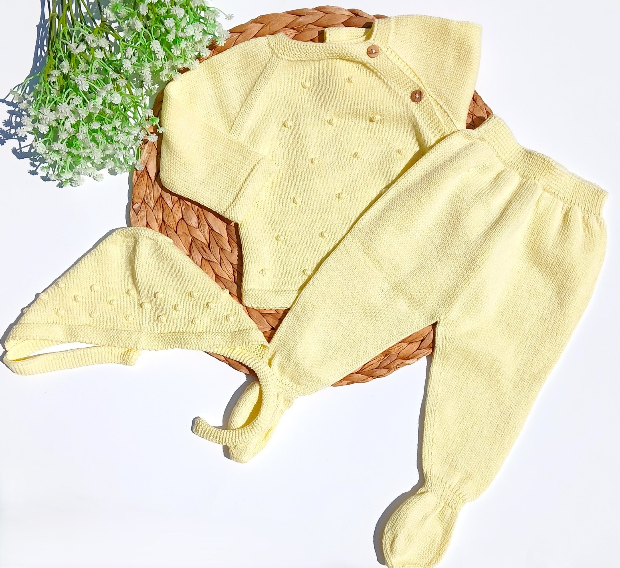 Yellow baby outfit with hat and pants on a white background