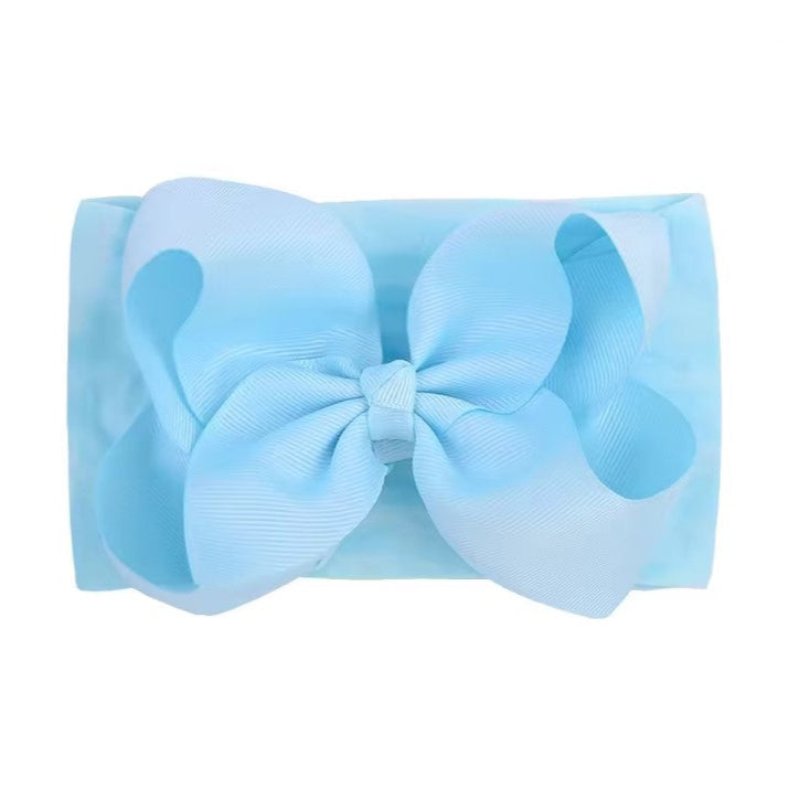 Light blue headband with a large bow on a white background,  large baby bow, baby headband