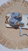 a pair of knit baby booties aviator with pacifier chain