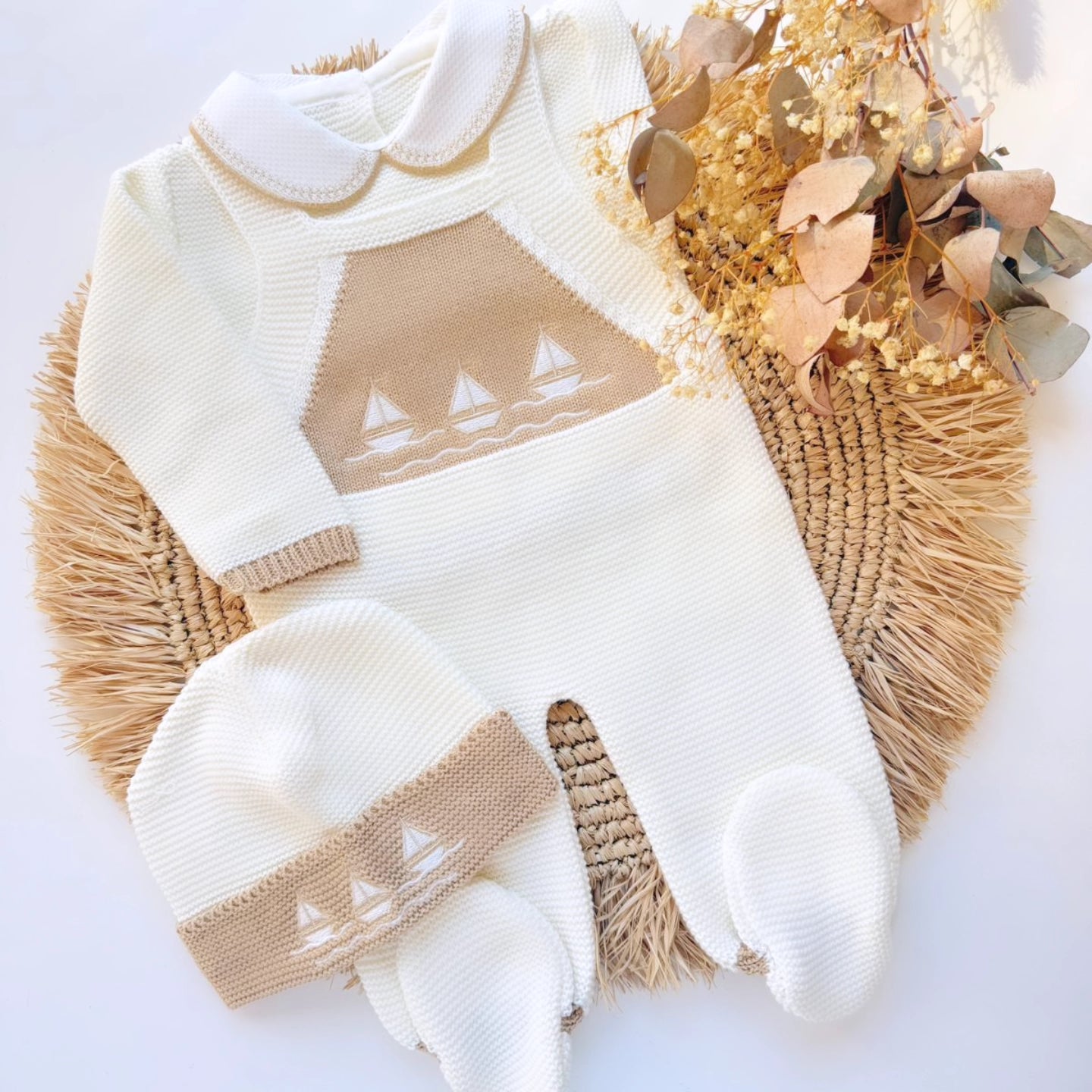 Baby outfit with white and beige patterned romper and hat on a light background newborn sailor navy theme
